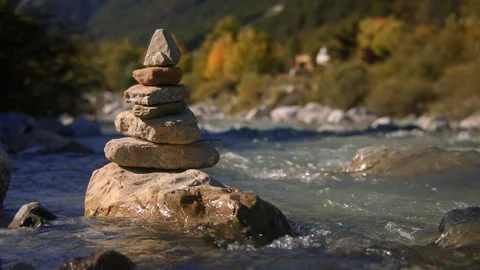 Close-up of a stacked stone cairn in alpine river Stock Footage 258959446