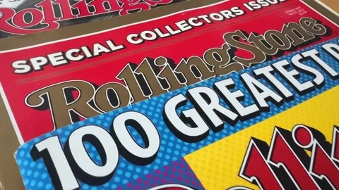 A close-up, stacked view of multiple Rolling Stone magazine issues Stock Footage 322074856