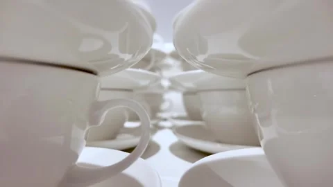Close Up Of Stacked White Porcelain Tea Cups And Saucers On A Table Minimalist Stock Footage 328089906