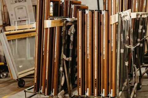 Close-up of stacked wooden window frames in metal workshop Stock Photos