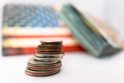 Close up of stacking coins against the backdrop of the American flag, USA one Stock Photos
