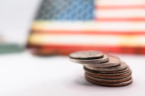 Close up of stacking coins against the backdrop of the American flag, USA one Stock-Fotos