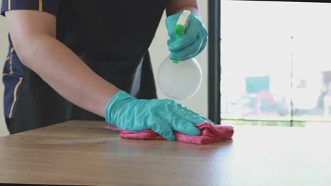 Close up Staff hand Restaurant workers are cleaning table and spraying disinf Stock Footage 147527484