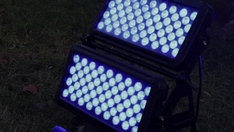 Close up of stage lighting blue LED in grass on ground. Stock Footage 257559707