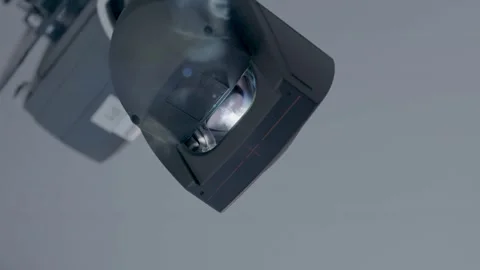 Close-Up of Stage Spotlight Emitting Smoke and Beams in Indoor Theater or Studio Stock Footage 334053339