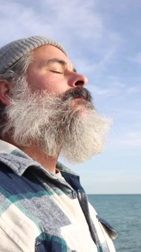 Close-up of a standing bearded man breathing fresh air closing his eyes. Ou.. Stock Footage 227759823