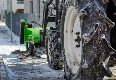 Close-up of standing  snow cleaning machine  covered with salt and snow at su Stock Photos