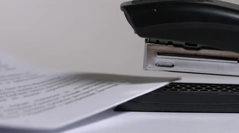 Close up of stapler, stapling sheets of paper Stock-Footage 64477912