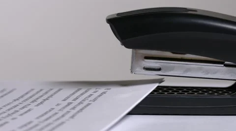 Close up of stapler, stapling sheets of paper  Video stock 64478092