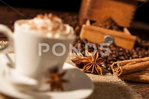 Close-up on star anise and cinnamon sticks with coffee cup Stock Photos