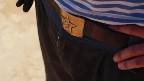 Close-up of a star with the symbol of the Soviet Union on badge on a man's belt Stock Footage 247020902