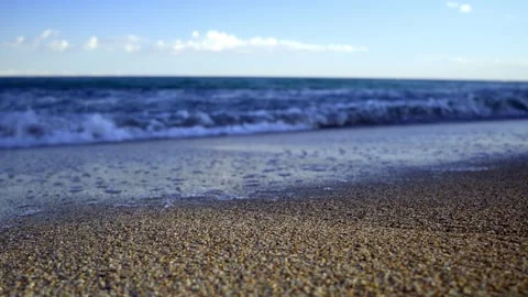 Close up static shot on the beach near the shore with the waves approaching the Stock Footage 218586624