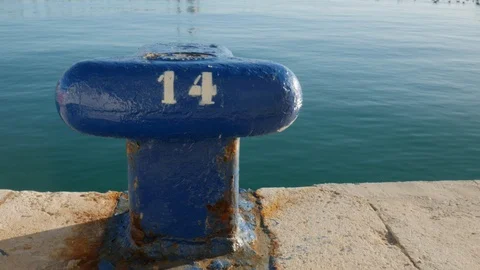 Close up static shot of a blue mooring bollard with number in white. Stock Footage 122065804