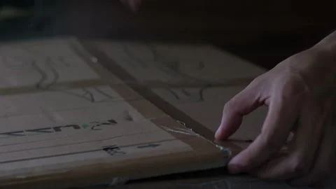 Close-Up Static Shot of Hands Opening Cardboard Box Видео 335940313