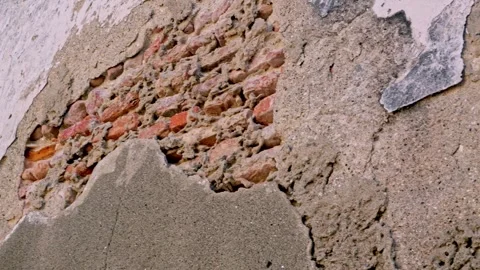 Close up static shot of a weathered, peeling historic concrete wall exposin.. Stock Footage 342029031