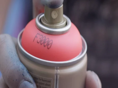 Close up static slow motion shot of spray paint being sprayed Stock Footage