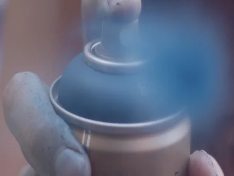 Close up static slow motion shot of spray paint being sprayed into lens. Stock Footage 85293564