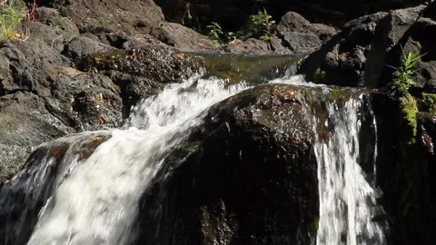 Close-up static white water rushing over rocks in a stream Stock Footage 272346837