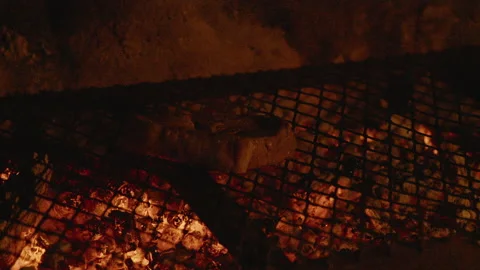 Close up of steak being placed on a flaming BBQ grill Stock Footage 135821200