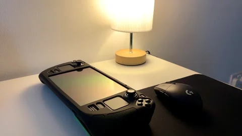 Close up of a steam deck handheld gaming console games mouse on computer desk Видео 325969192
