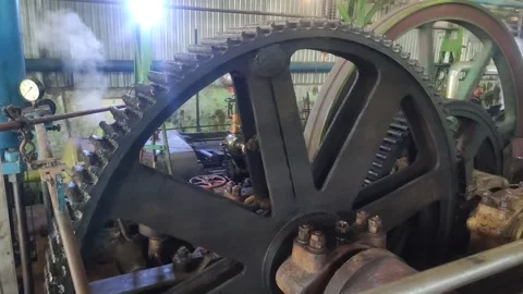 Close-up of steam engine gearwheel and flywheel transmission Stock Footage 309215917