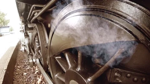 Close up of steam engine wheels starting to move. in motion Stock Footage 43618250