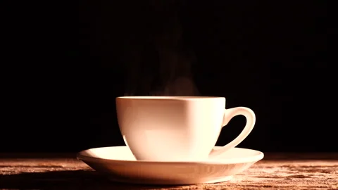 Close-up steam rises from cup of coffee with morning sunlight Stock Footage 291958969
