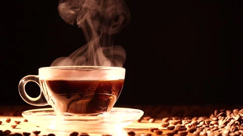 Close-up steam rises from cup of coffee with morning sunlight Stock Footage 292489612