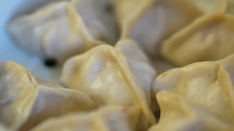 Close-up of steamed khinkali in a white ceramic steamer. Stock Footage 332295407