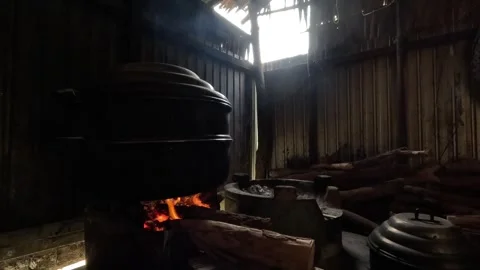 Close-up of a steamer pot on a burning firewood stove in a rustic kitchen. Stock Footage 343591672