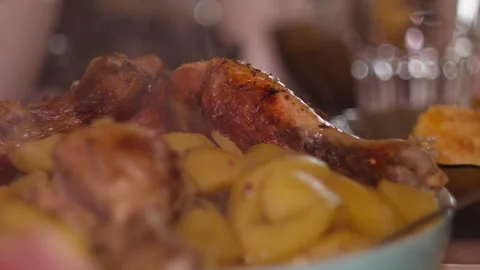 Close-up of Steaming Baked Chicken Drumsticks with Roasted Potatoes Stock Footage 335229737