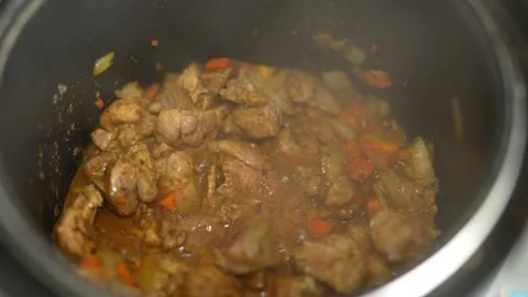 Close-up of steaming chicken stew with carrots and onions in pot Stock Footage 331244130