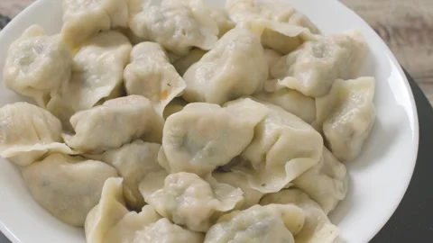 Close-up of Steaming Dumplings on White Plate with Visible Filling Video stock 336527268