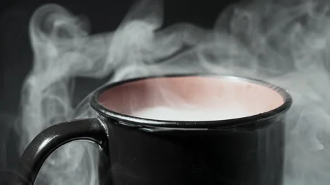 Close-Up of Steaming Hot Beverage in a Vintage Enamel Mug Stockbeeldmateriaal 337119893