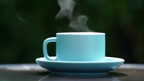 Close-up steaming hot coffee, Hot ceramic white coffee cup  Stockbeeldmateriaal 253536336