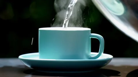 Close-up steaming hot coffee, Hot ceramic white coffee cup  Stockbeeldmateriaal 253536342