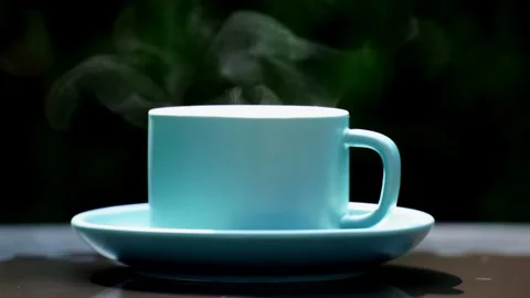 Close-up steaming hot coffee, Hot ceramic white coffee cup  Stockbeeldmateriaal 253536381