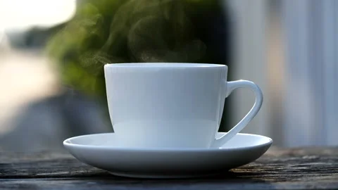 Close-up steaming hot coffee or tea cup, slow motion.Hot Coffee Drink Concept Stock Footage 143158046