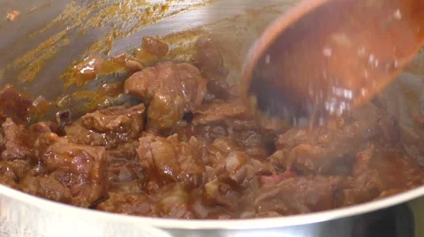 Close-up steaming meat cubes for a goulash dish in pot Stock Footage 48419619