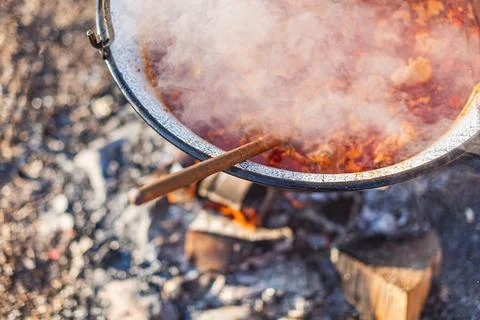 Close-Up of a Steaming Pot Preparing Traditional Cooking Outdoors on a Rust.. Stock Photos