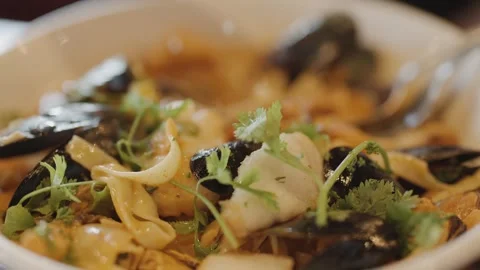 Close-Up of Steaming Seafood Chowder With Fresh Herbs Stock Footage 314770021