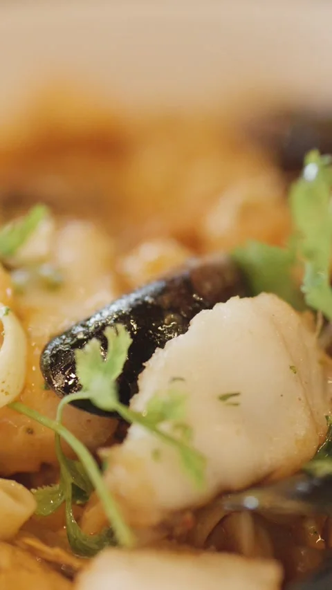 Close-Up of Steaming Seafood Chowder With Fresh Herbs Stock Footage 314869281