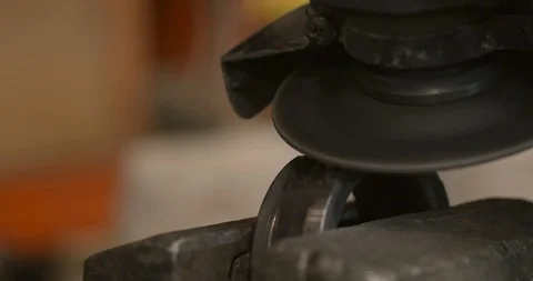 Close up of steel worker with angle grinder making hot glowing sparks Stock Footage 120618729