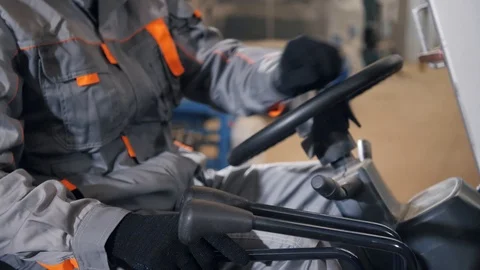 Close - up steering wheel and levers. man driving a forklift through a warehouse Stock Footage 96016816