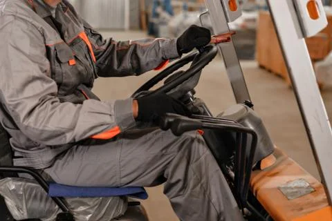 Close - up steering wheel and levers. man driving a forklift through a warehouse Stock Photos