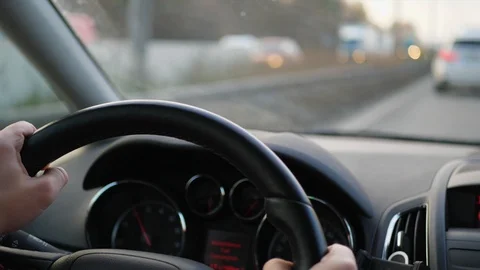 Close-up of steering wheel during car driving on rush road Stock Footage 99933255