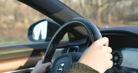 Close up of steering wheel of a modern car slowly passing several people Stock Footage 142800598