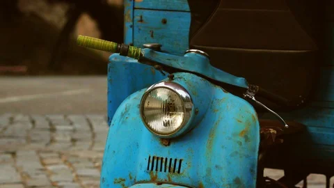 Close-up of the steering wheel of an old blue motorcycle that stands on the road Stock Footage 104924093