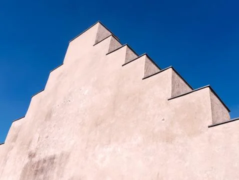 Close-up of stepped gable, a step pattern design above the roof against blue sky Foto stock