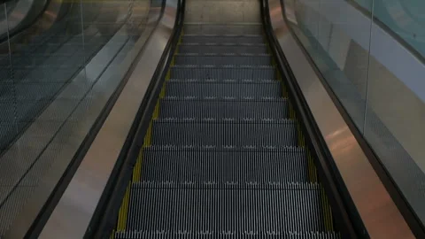 A close-up of the steps of the escalator moving down. A view from the eyes. Stock Footage 111369706